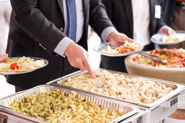 A businessman severing himself food at a catered corporate lunch